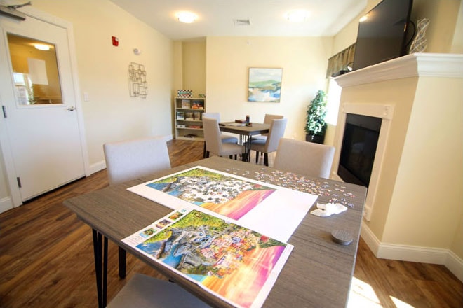 Activity room with fireplace and puzzle tables