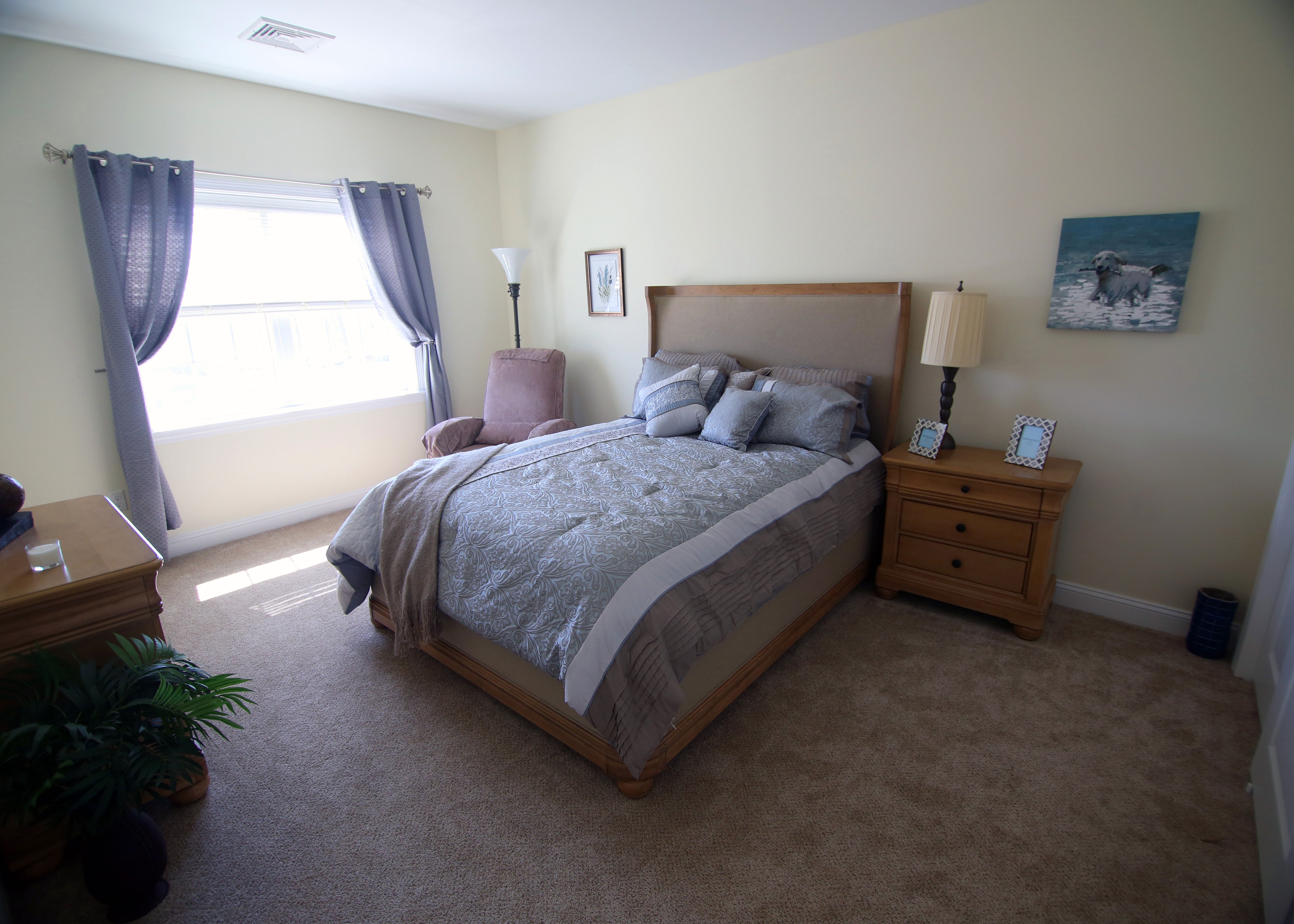 Master bedroom with blue curtains