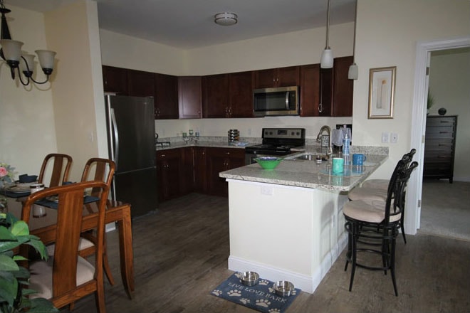 Kitchen with dark cabinetry and granite island